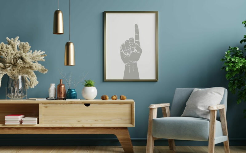 Poster mockup with vertical frames on empty dark green wall in living room interior with blue velvet armchair.3D rendering